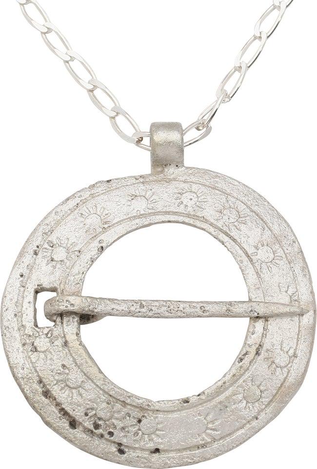 RARE VIKING PROTECTIVE BROOCH NECKLACE 10th C.: Bronze, just under 1 3/4" diameter of slightly domed form. Broadband with line borders flanking a series of radiant sun motifs, probably representing Sol the sun deity. Slotted for the captive cross p