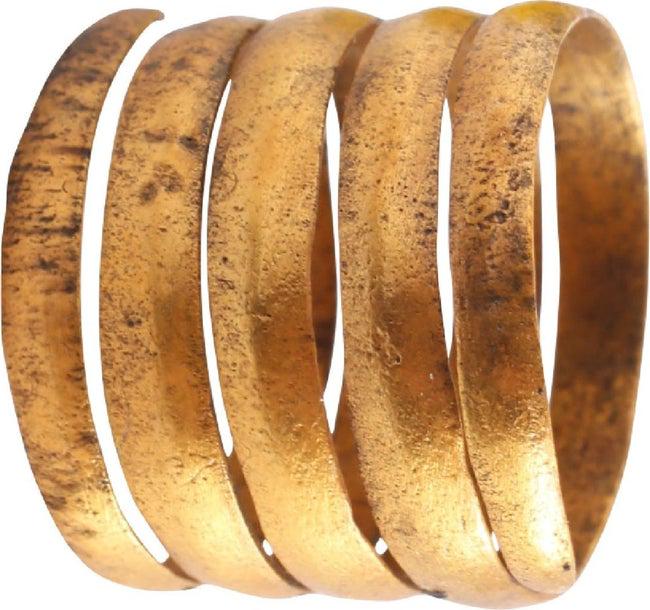 FINE VIKING COIL RING, 10th CENT AD SIZE 10 3/4: Gilt bronze. Size 10 3/4 . Rounded face band in 3 1/2 coils to over 1/2" width. Lightly textured from burial. Sound wearable condition and professionally refurbished with the 24karat gold surface rest