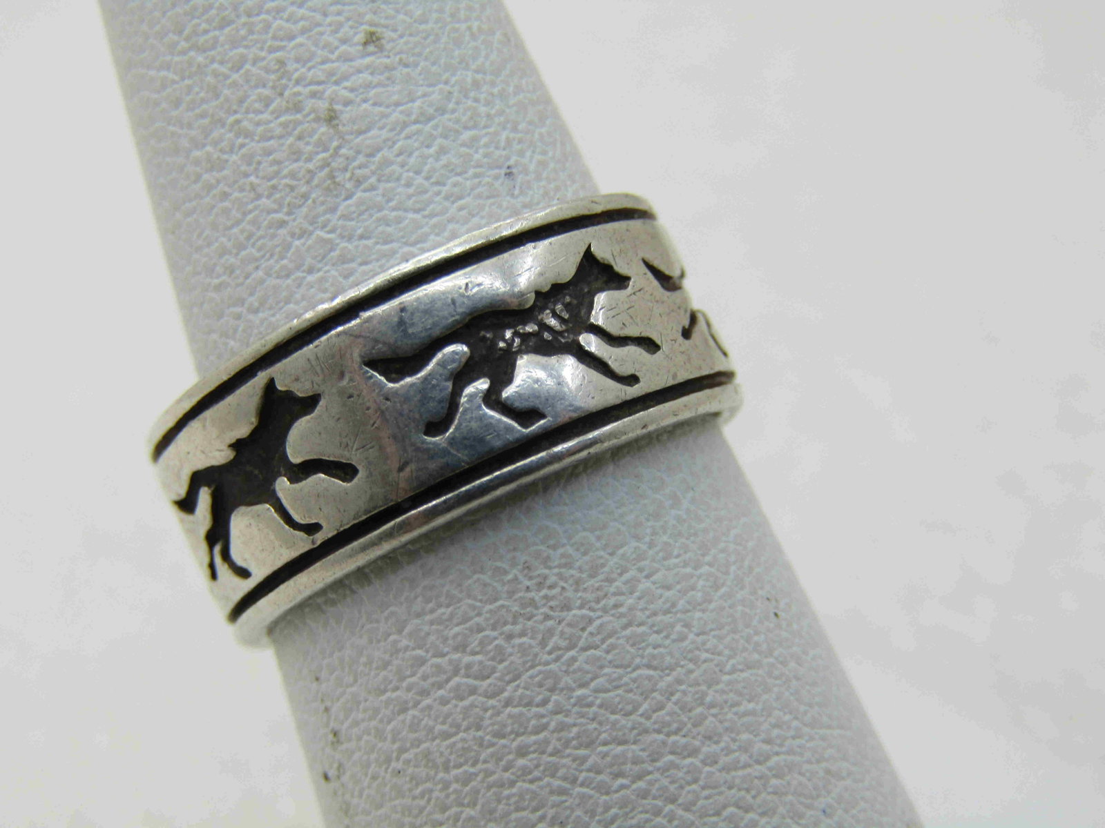 Vintage Southwestern Sterling Wolf Ring, Unisex, Sz. 8,: Vintage Southwestern Sterling Wolf Ring, Unisex, Sz. 8, 8mm wide, Signed $ and marked sterling and tested. Appx. Weight is 5.55 grams. Age is 1970's-1980's. Wolves are recessed and blackened as is gro