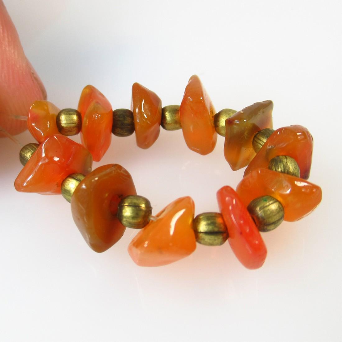 23.26 Ct Natural 11 Drilled Orange Carnelian Unshaped: No Reserve! Title: 23.26 Ct Natural 11 Drilled Orange Carnelian Unshaped Beads Stone Clarity: Semi-Transparent Gemstones: Natural Carnelian Beads Carat Weights: 23.26 Size/Dimensions: 7.5x3.6 - 8.2x3.