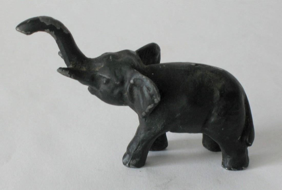 Vintage cast iron elephant paperweight.: Title: Vintage cast iron elephant paperweight. Description: Nice vintage cast iron elephant paperweight in old original paint. This is quite heavy. Dimension: 3” Circa: 1930's Shipping: Domestic: Fl
