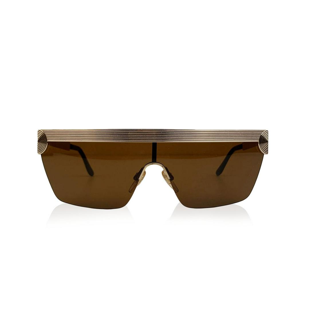Valentino Vintage One Piece Shield Sunglasses V614 903: Vintage Valentino shield sunglasses V614 - 903 from the 80s. Beautiful half-rim frame in gold metal with ribbed and circle details. Brown one piece lens. Adjustable nose pads. 100% UV protection. Made