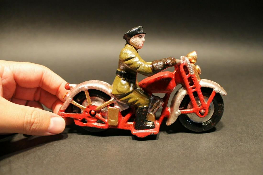Cast Iron Toy Motorcycle 1 Patrol Rider: 6 1/2" Long x 4" Tall Such a neat reproduction cast iron motorcycle! As you can see this heavy cast iron pull toy motorcycle was wonderfully hand painted and distressed to look like an original antiqu