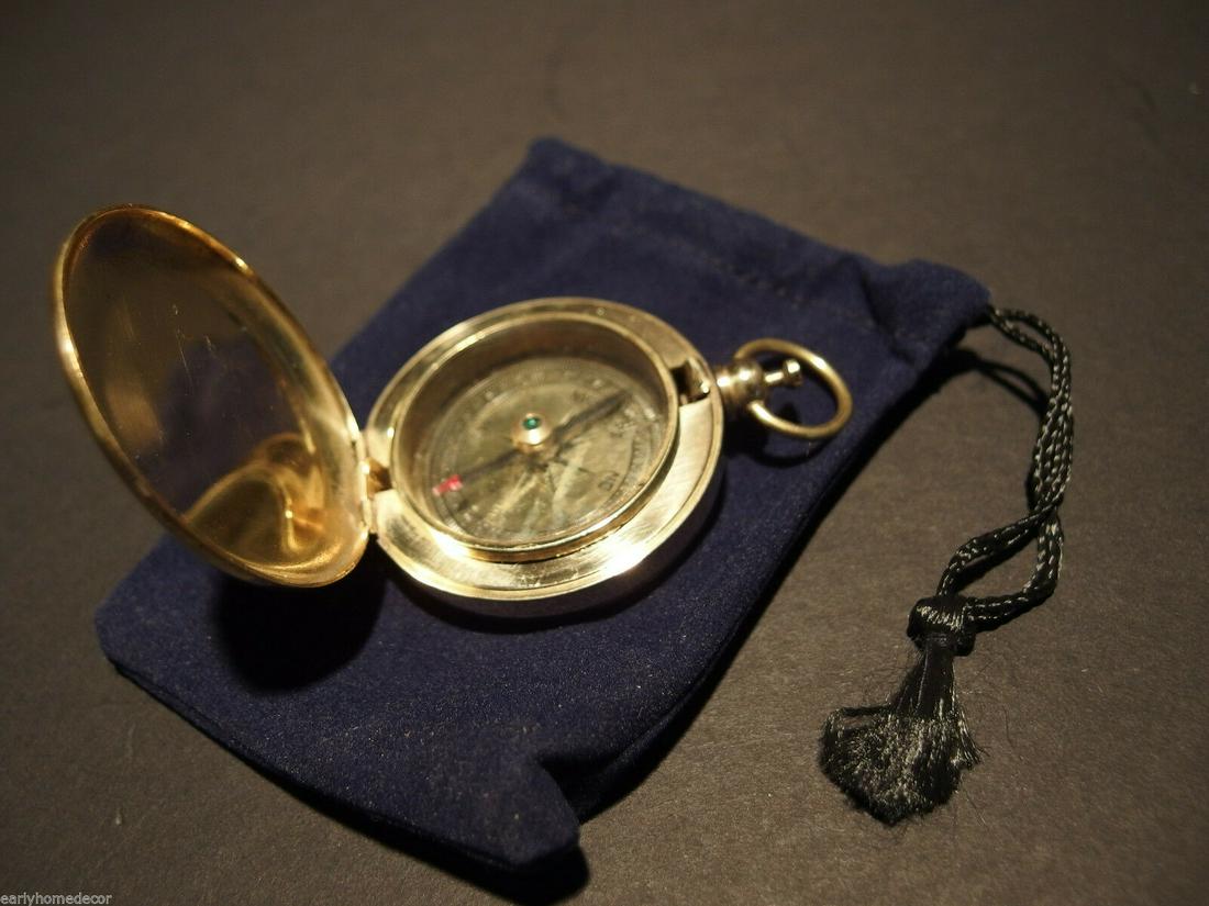 Brass Pocket Compass flip lid Signal mirror with bag: 2 1/2" tall 1 7/8" Wide Nice reproduction of an antique compass with pocket watch type lid. The lid opens with the push of the button on the top. When opened the polished inside of the lid makes for a