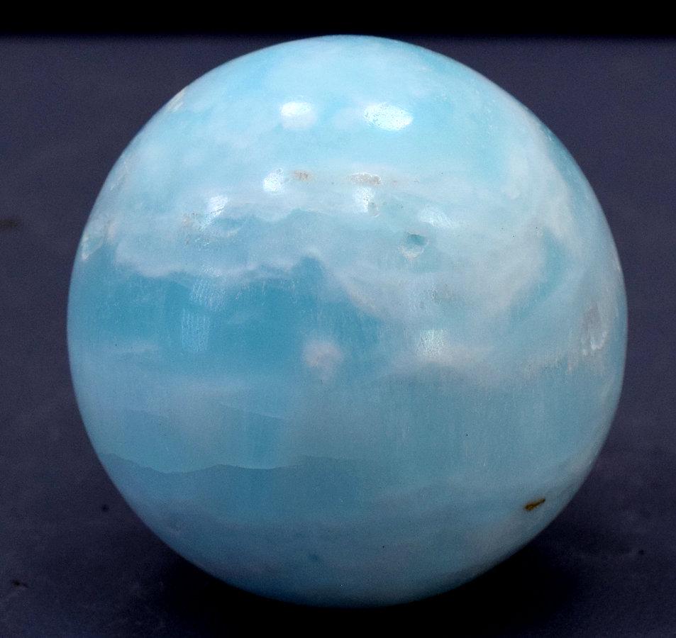 Carribean Calcite Sphere Ball , Blue Calcite Gemstone: carribean calcite, calcite Description Carribean Calcite Sphere Ball , Blue Calcite Gemstone Crystal Stone - 201 Gram , 51*51*51 mm This listing is for this exact Caribbean calcite aragonite ball. The