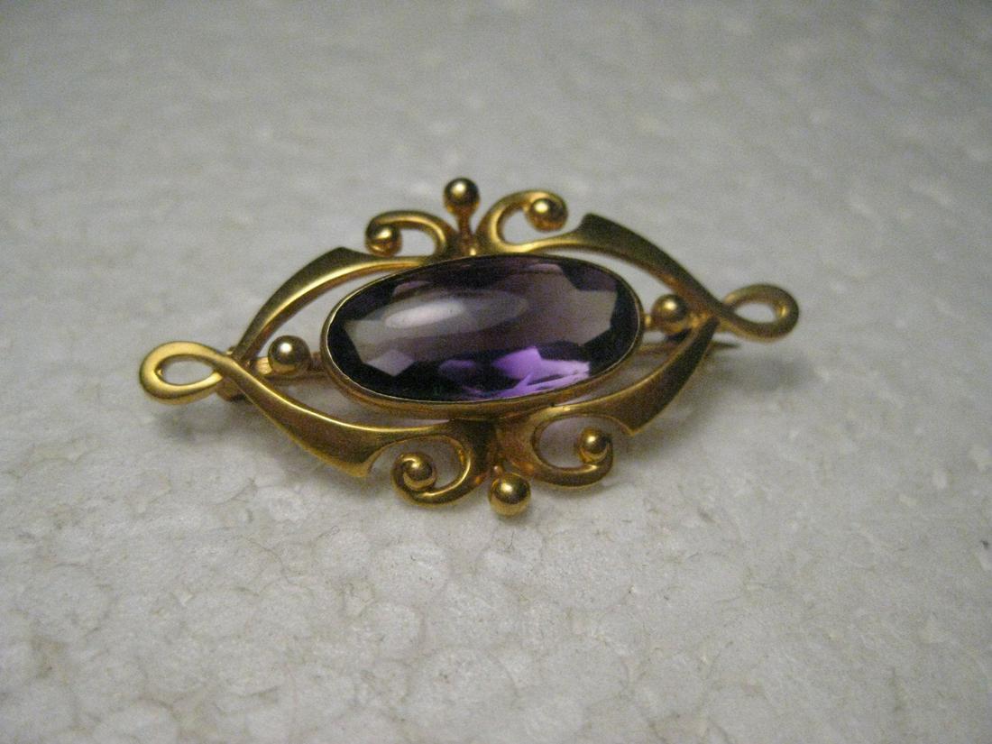 Vintage Estate 14kt Art Nouveau Amethyst Brooch, Oval,: Vintage Estate 14kt Gold Art Nouveau Oval Brooch with Scrolled Setting. It has an amethyst colored stone that is purple with clear areas and darker areas - from underneath - the stone looks blue and p