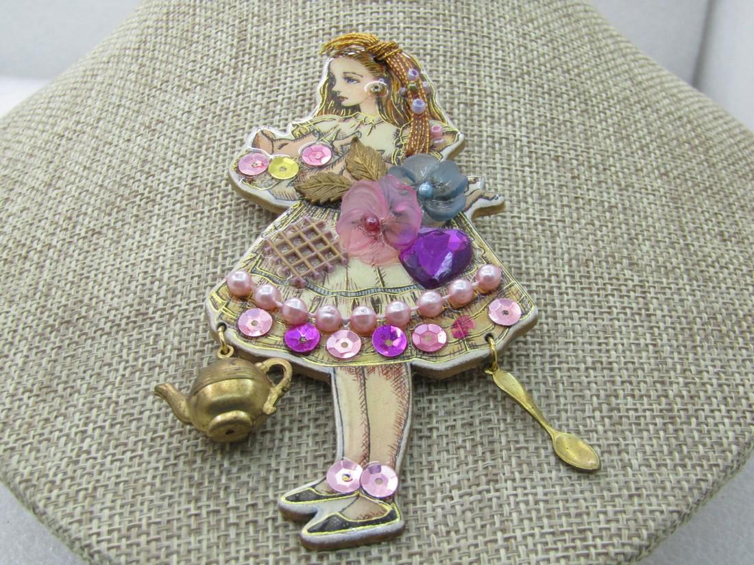 Vintage Alice In Wonderland Rhinestone Brooch, holding: Vintage Alice In Wonderland Rhinestone Brooch, holding Pig, Creations by Frances, 4" tall and 2" wide. Accented with shades of pink rhinestones and seqins as well as pink faux pearls and pink and gree
