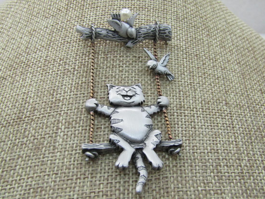 Vintage Swinging Cat & Bird with Branch Brooch, Signed: Vintage Swinging Cat & Bird with Branch Brooch, Signed JJ, Two-Tone. The Brooch is 3" tall and 1.5" wide with a branch on top and a bird on the branch and one on the rope of the swing. The rop is gold
