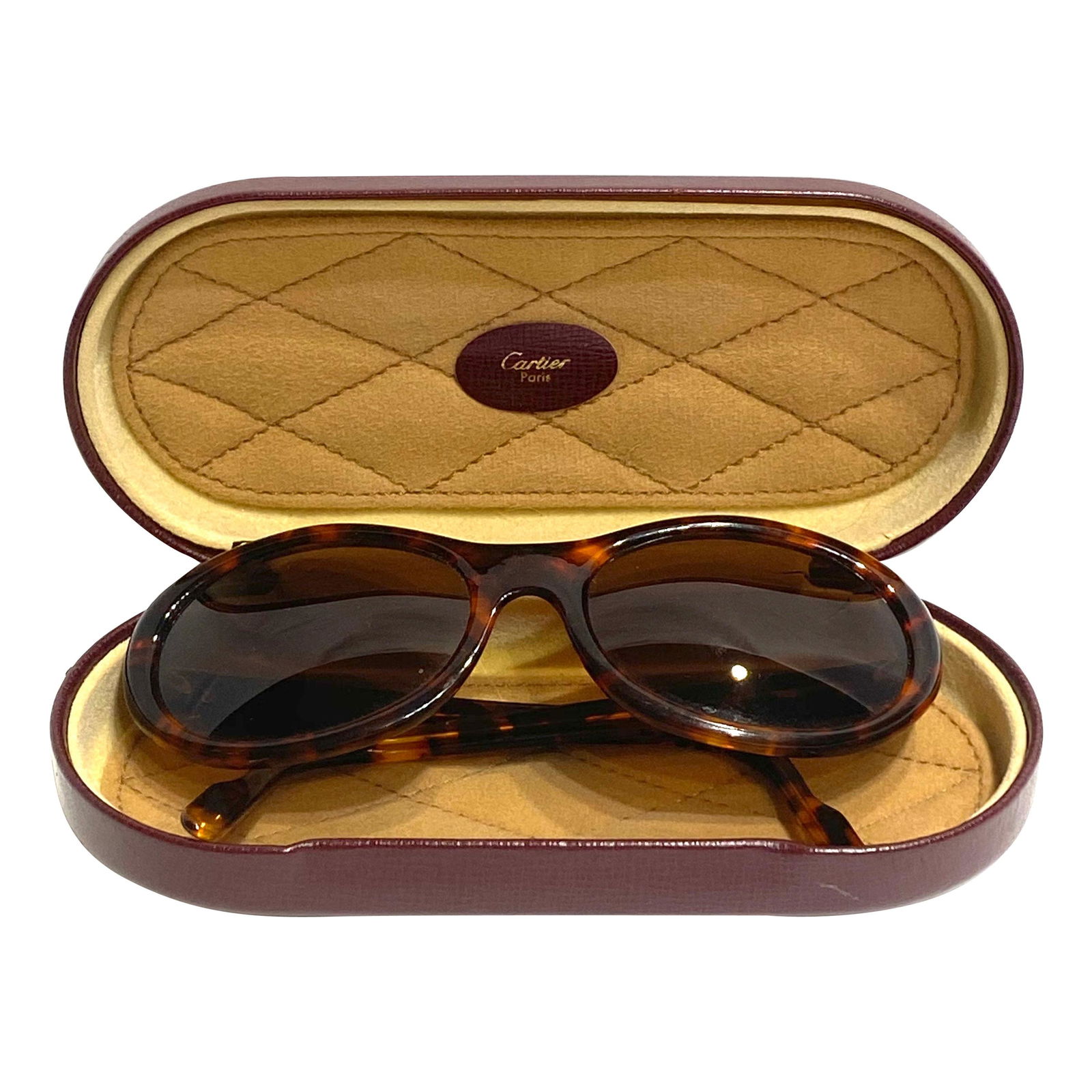 Vintage Cartier Paris Brown Round Sunglasses: Product details: Circa 1990. Featuring round, oval shaped with tortoise shell finish frame and brown lens sunglasses. Yellow and white gold signature Cartier detail hinge on each side. Signed Cartier