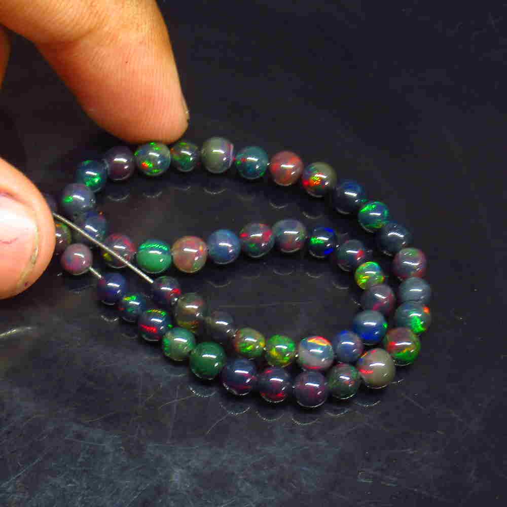 20.00 Ctw Natural 49 Drilled Black Opal Ball Beads: Title: 20.00 Ctw Natural 49 Drilled Black Opal Ball Beads Stone Clarity: Translucent Gemstones: Black Opal Beads Size/Dimensions: 20 Carat Weights: 3.80 to 5.30 mm / 49 PC's Additional Information: Dr