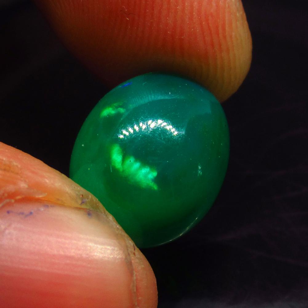 4.20 Ct Natural Ethiopian Green Fire Opal Oval Cab: No Reserve! Title: 4.20 Ct Natural Ethiopian Green Fire Opal Oval Cab Stone Clarity: Translucent Gemstones: Natural Black Opal Carat Weights: 4.2 Size/Dimensions: 14.00 x 11.00 x 6.00 mm Additional In