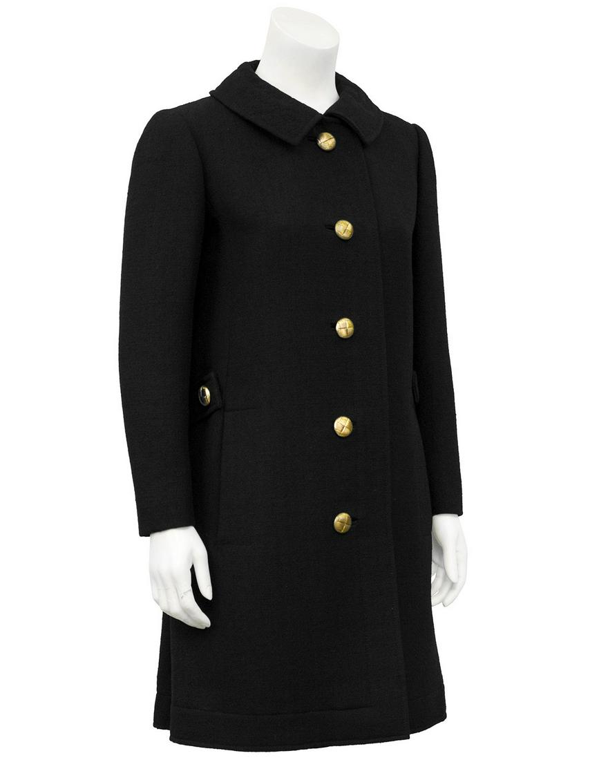 Lanvin Black Wool 3/4 Coat: Brand: Lanvin Title: Lanvin Black Wool 3/4 Coat Additional Information: Lanvin black wool 3/4 length coat circa the 1960's. Features include a peter pan collar, brass tone quilted buttons, side vertic