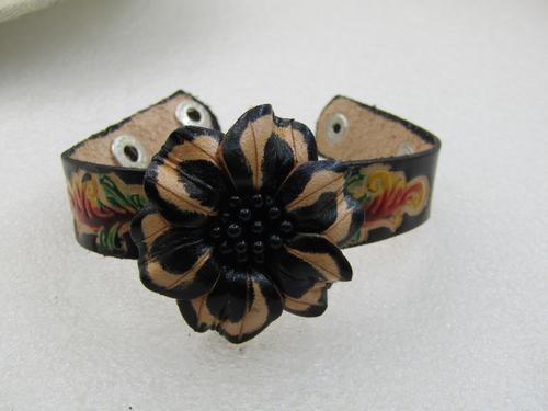 Vintage Carved Floral Leather Bracelet, Double Snap: Vintage Carved Floral Leather Bracelet, Double Snap Clasp, 8", black and natural colored flower blossom on top center that is about 1.5" across. The band is a pressed scrolled design set in the black