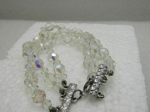 Vintage Aurora Borealist Crystal Beaded Bracelet,: Vintage Aurora Borealist Crystal Beaded Bracelet, Triple Strand, 7" with silver tone decorative art deco end caps, spring clasp. Appx. 1" wide with round faceted crystal beads that are appx. 7.5mm and