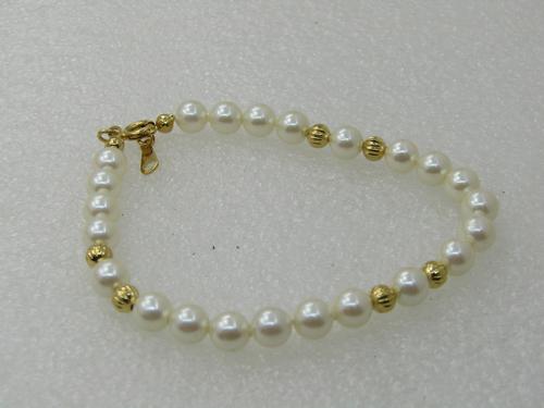 Vintage 5mm Faux Pearl Gold Beaded Bracelet, 7.75": Vintage 5mm Faux Pearl Gold Beaded Bracelet, 7.75" Signed Avon, Very good Condition. Spring clasp. Fluted gold tone beads are in three sections of the bracelet. Like new condition. (INV W.BL14MX 4 SS2