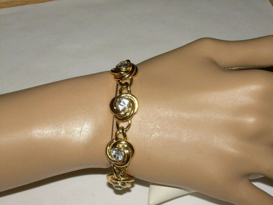 Vintage Goldtone CZ Link Bracelet, 7": Vintage gold tone link bracelet. Each link has a circular design with a bezel set CZ. Each CZ is approximately 7 mm. The bracelet is 7" long. Bracelet has a snap clasp. Bracelet is not signed by the d