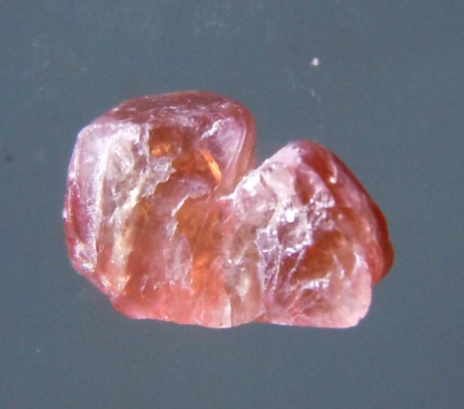 1.58 CT TWINNED RUBY - UNTREATED GEMSTONE: Title: 1.58 CT TWINNED RUBY - UNTREATED GEMSTONE Origin: Mogok Township, Mandalay Reg. Myanmar Size: 0.74x0.5x0.34 cm / 0.31 gram twinned, orange-red ruby crystal with naturally rounded shape Reserve:
