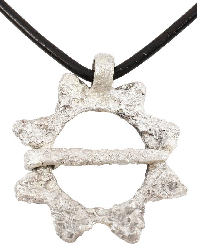 VIKING PROTECTIVE BROOCH NECKLACE, 10TH-11TH CENTURY AD: Silvered bronze. Just over 1 1/8” diameter. Circular with eight triangles on the perimeter. Evidence of pellet decoration to some. Those same pellet decorated triangles are encountered on Viking lun
