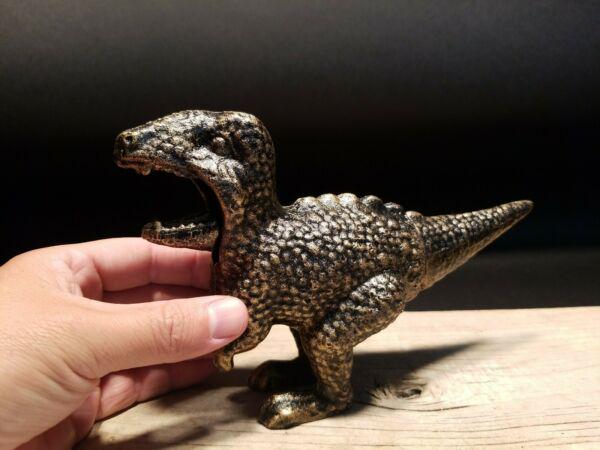 Cast Iron Dinosaur Tyrannosaurus Rex Nut Cracker: 8 1/2" long x 5 1/4" tall Full open mouth seems to be about 1 1/2"... closed is about 3/4" to 1".. hard to tell.. Such a neat all metal Dinosaur Tyrannosaurus Rex Nut Cracker. The tail acts as the nut