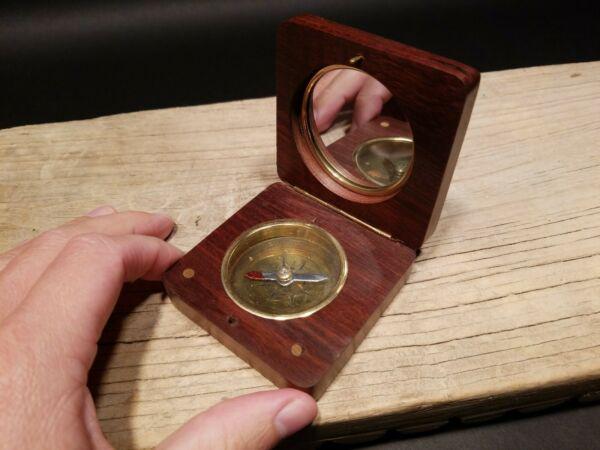 Wood and Brass Anchor Compass: 2 7/8" x 2 7/8" x 1" Such a neat reproduction antique compass. This is a hardwood and brass compass with a brass inlay anchor on the lid. The inside has a brass and glass compass with a signal mirror 
