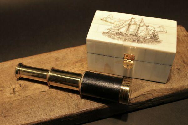 Sailboat Bone & Wood Scrimshaw Box w Telescope: Box measures 4 3/4" Long x 2 5/8 wide x 2 5/8" tall Telescope measures 3 3/8" Long closed x 6 1/4" open Nice quality reproduction of a traveling pocket telescope and cap. This piece is all brass wrapp