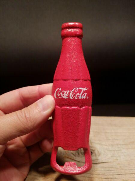 cast Iron Red Coca Cola Bottle Opener: 5 1/2" Long x 1 1/2" Nice reproduction coca cola bottle opener shaped like a coke bottle. Great for use or display as a collectible. Hard to tell its age! All our items come with a 100% customer satis