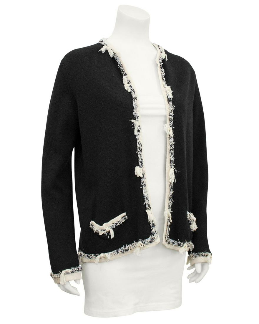 Chanel Black 100% Cashmere Fringe Cardigan: Brand: Chanel Title: Black 100% Cashmere Fringe Cardigan Additional Information: Chanel black 100% cashmere open front cardigan from 2005. Contrasting cream trim with black, white and cream deconstruc