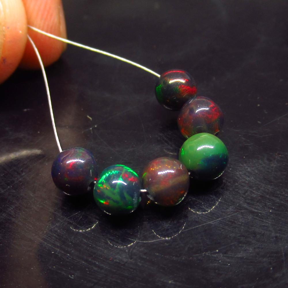 4.07 Ctw Natural 6 Drilled Black Opal Ball Beads: No Reserve! Title: 4.07 Ctw Natural 6 Drilled Black Opal Ball Beads Stone Clarity: 4.07 Gemstone: Black Opal Beads Size/ Dimensions: 4.07 Carat Weights:5.10 to 5.30 mm / 6 PC's Additional Info: Drille