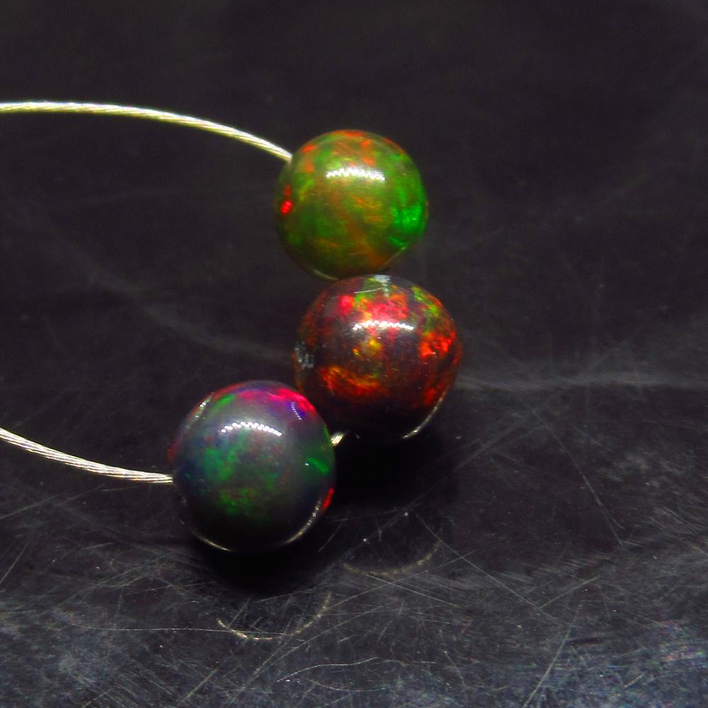 2.75 Ctw Natural 3 Drilled Black Opal Ball Beads: No Reserve! Title: 2.75 Ctw Natural 3 Drilled Black Opal Ball Beads Stone Clarity: Translucent Gemstone: Black Opal Beads Carat Weight: 2.75 Size/Dimensions: 5.60 to 6.10 mm / 3 PC's Additional Inform