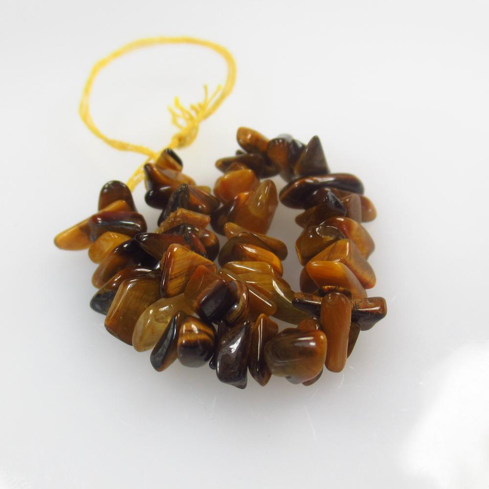 19.04 Ctw Natural 56 Tiger's Eye Drilled Unshaped Beads: No Reserve! Title: 19.04 Ctw Natural 56 Tiger's Eye Drilled Unshaped Beads Stone Clarity: Opaque Gemstone: Tiger's Eye Beads Carat Weight: 19.04 Size/Dimensions: 5.0x4.3 - 8.9x5.1 mm / 56 PC's Additio