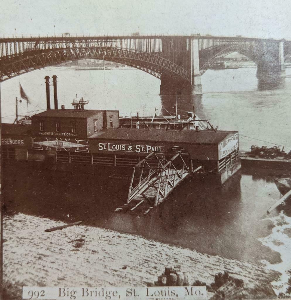 ca. 1880 EADS BRIDGE ST LOUIS MISSOURI w ST. LOUIS &: Circa 1880s Stereoview; Identification on image, "992 Big Bridge, St. Louis, Mo.". Depiction of Eads Bridge over the Mississippi River with LINE Freight & Ticket Office on water. Photographic stereovi
