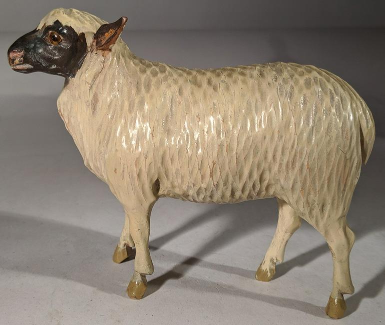 Toy Carved Lamb: Title: Toy Carved Lamb Date: Early 1900's Origin: American Dimensions: 4" H x 5" L Provenance/Additional Info:Toy Carved Lamb - carved & painted folksy lamb with glass eyes. Shipping: Domestic: Flat-r