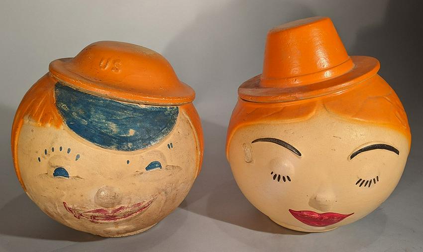 Large Stoneware Face Cookie Jars: Title: Large Stoneware Face Cookie Jars Dimensions: 8 1/2" H & 9" H Provenance/Additional Info:Large amusing stoneware face cookie jars - Roly-Poly Heads of a Man and Woman, in partially glazed stonew