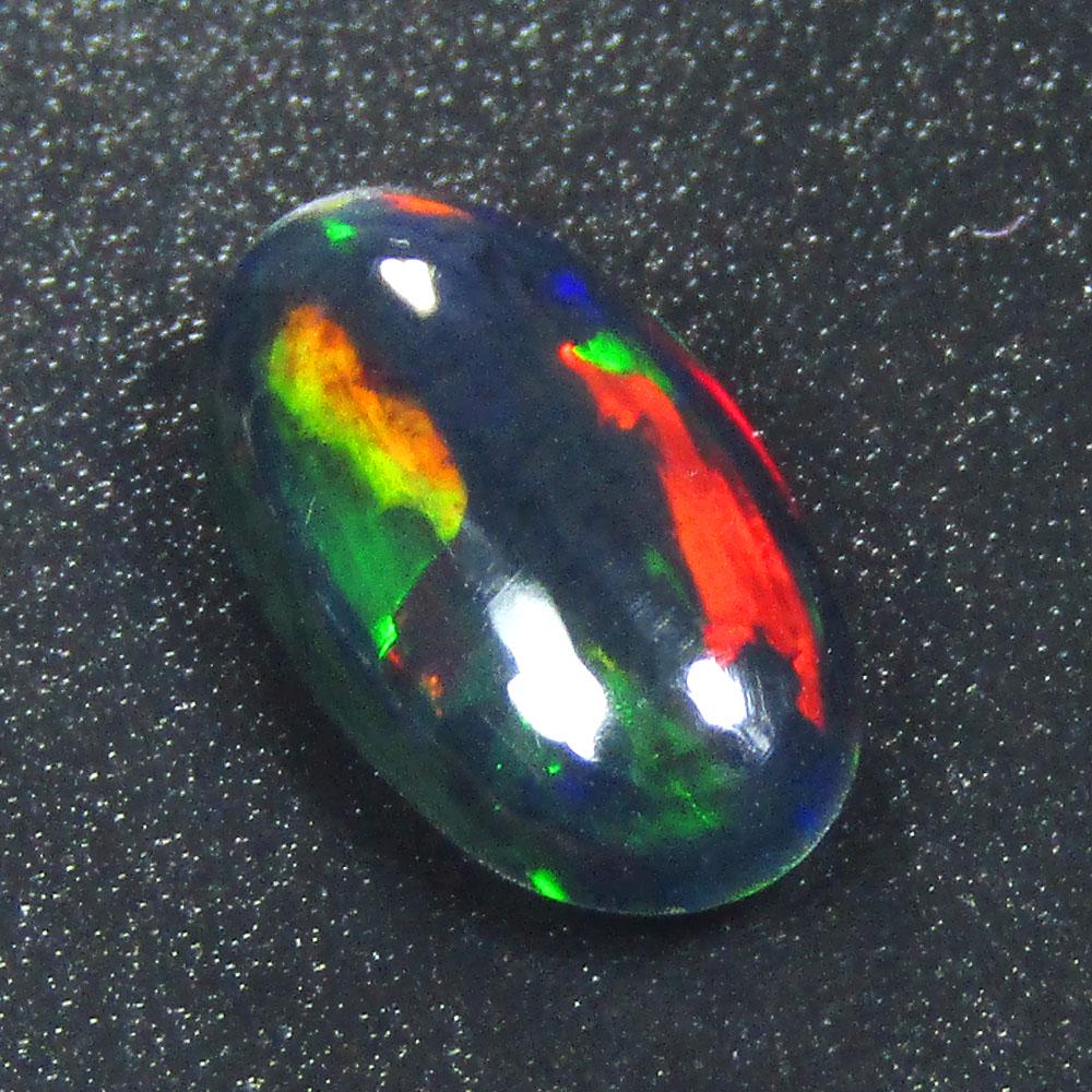 1.45Cts Natural Multi color Black Opal Oval Cabochon: Title: 1.45Cts Natural Multi color Black Opal Oval Cabochon Good Luster loose gemstone Carat Weights: 1.45 Size/Dimension: 10.80x6.10x3.30 MM Additional Info: HEATED WITH PLAY OF COLOR Reserve: $10.00