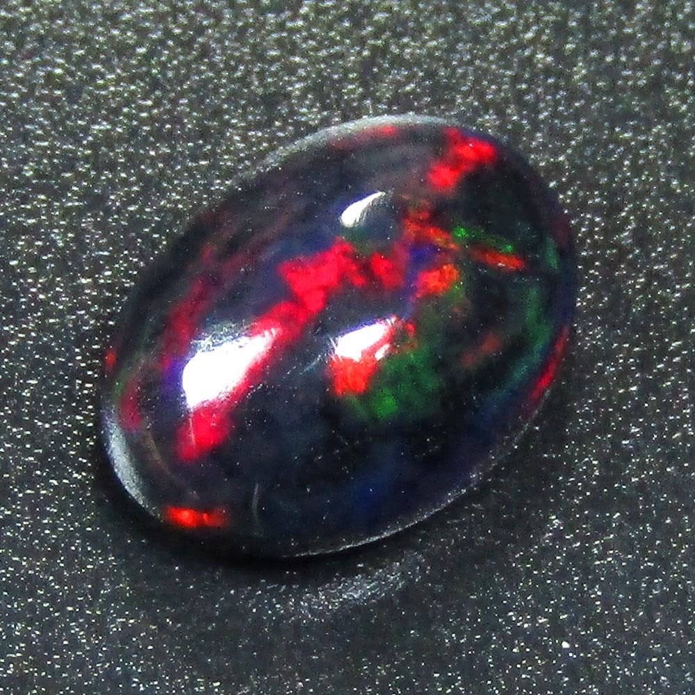 1.15Cts Natural Multi color Black Opal Oval Cabochon: Title: 1.15Cts Natural Multi color Black Opal Oval Cabochon Good Luster loose gemstone Carat Weights: 1.15 Size/Dimension: 9.60x6.90x3.60 MM Additional Info: HEATED WITH PLAY OF COLOR Reserve: $10.00 