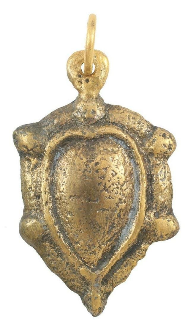 ANCIENT VIKING HEART NECKLACE C.1000 AD: Late example of the heart in its naturalistic form with a rounded top and a pointed bottom. Especially high rounded double border. Just over 1" height, made by the open face mold technique. The early 