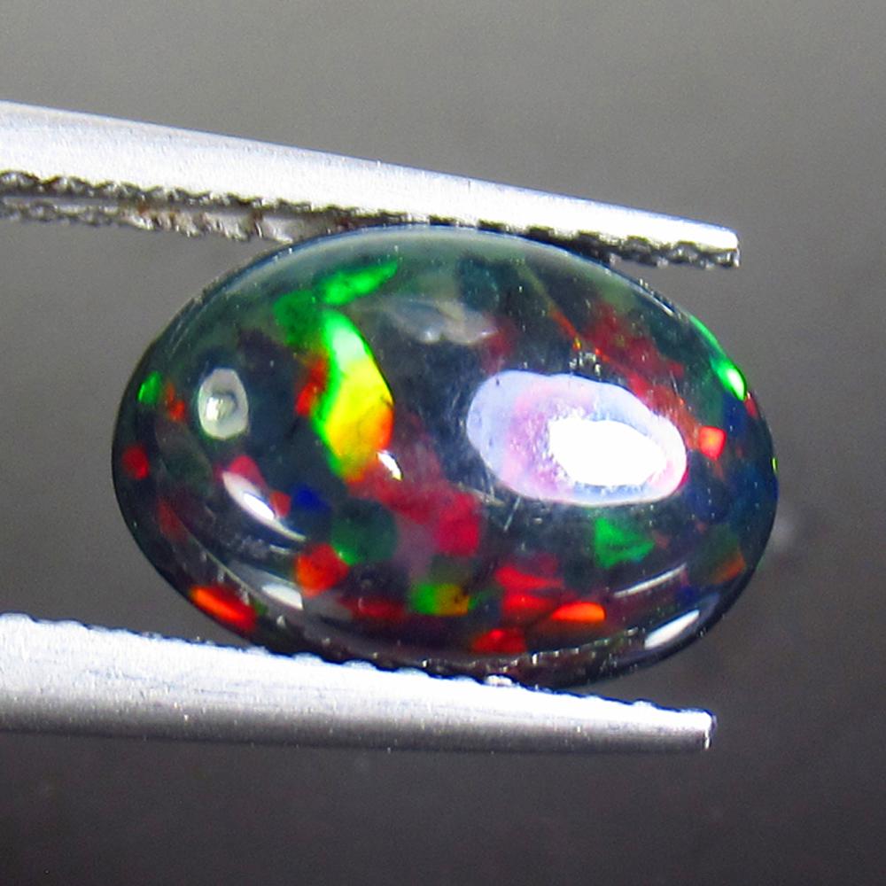 1.77 Ctw Natural Ethiopian Black Fire Opal Oval Cab: Title: 1.77 Ctw Natural Ethiopian Black Fire Opal Oval Cab Stone Clarity: Opaque Gemstones: Black Opal Size/Dimensions: 1.77 Carat Weights: 11.40 x 8.10 x 4.00 mm Additional Information: Excellent Ova