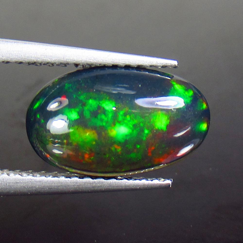 2.24 Ctw Natural Ethiopian Black Fire Opal Oval Cab: Title: 2.24 Ctw Natural Ethiopian Black Fire Opal Oval Cab Stone Clarity: Opaque Gemstones: Black Opal Size/Dimensions: 2.24 Carat Weights: 12.70 x 7.70 x 4.80 mm Additional Information: Excellent Ova