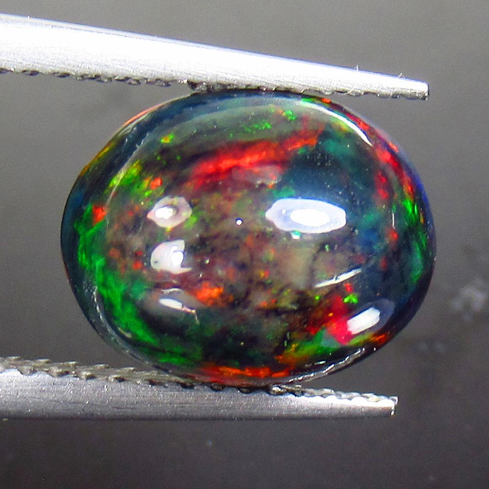 2.65 Ctw Natural Ethiopian Black Fire Opal Oval Cab: Title: 2.65 Ctw Natural Ethiopian Black Fire Opal Oval Cab Stone Clarity: Opaque Gemstones: Black Opal Size/Dimensions: 2.65 Carat Weights: 11.20 x 8.90 x 6.10 mm Additional Information: Excellent Ova