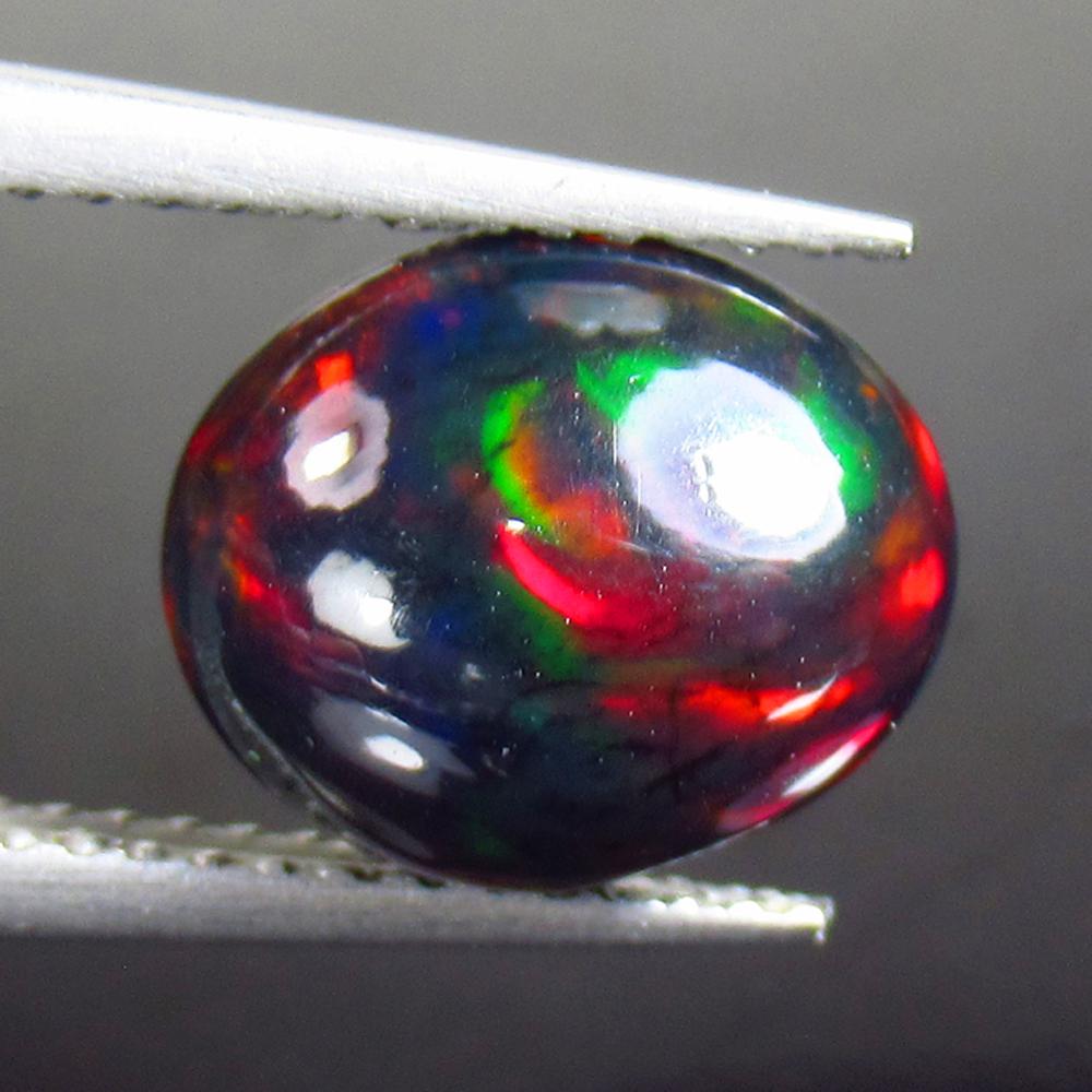 2.16 Ctw Natural Ethiopian Black Fire Opal Oval Cab: Title: 2.16 Ctw Natural Ethiopian Black Fire Opal Oval Cab Stone Clarity: Opaque Gemstones: Black Opal Size/Dimensions: 2.16 Carat Weights: 10.60 x 8.90 x 5.20 mm Additional Information: Excellent Ova