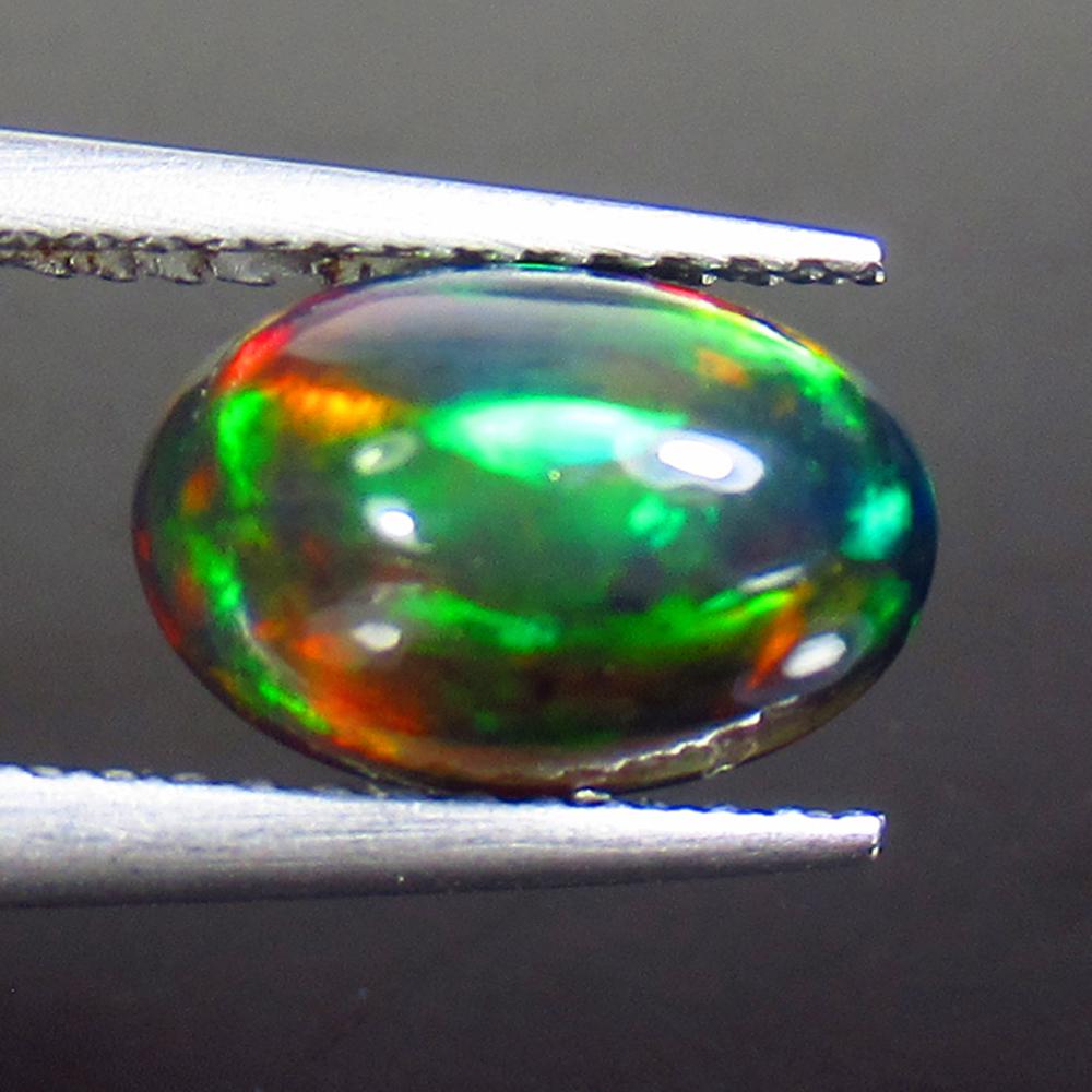 1.69 Ct Natural Ethiopian Black Fire Opal Oval Cab: Title: 1.69 Ct Natural Ethiopian Black Fire Opal Oval Cab Stone Clarity: Opaque Gemstones: Black Opal Size/Dimensions: 1.69 Carat Weights: 9.90 x 6.70 x 5.40 mm Additional Information: Excellent Oval 