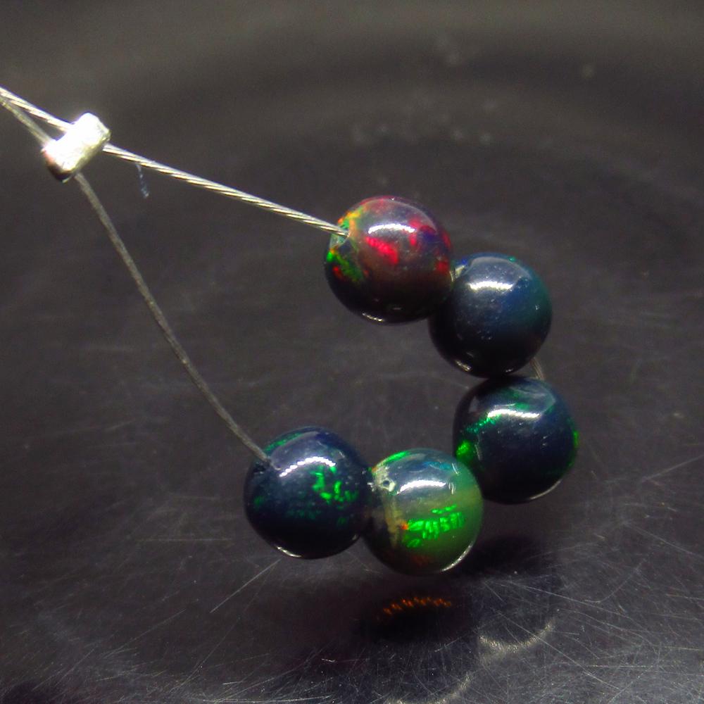 2.78 Ct Natural 5 Drilled Black Fire Opal Ball Beads: No Reserve! Title: 2.78 Ct Natural 5 Drilled Black Fire Opal Ball Beads Stone Clarity: Translucent Gemstones: Natural Black Opal Beads Carat Weights: 2.78 Size/Dimensions: 5.00 to 5.30 mm / 5 PC's Add