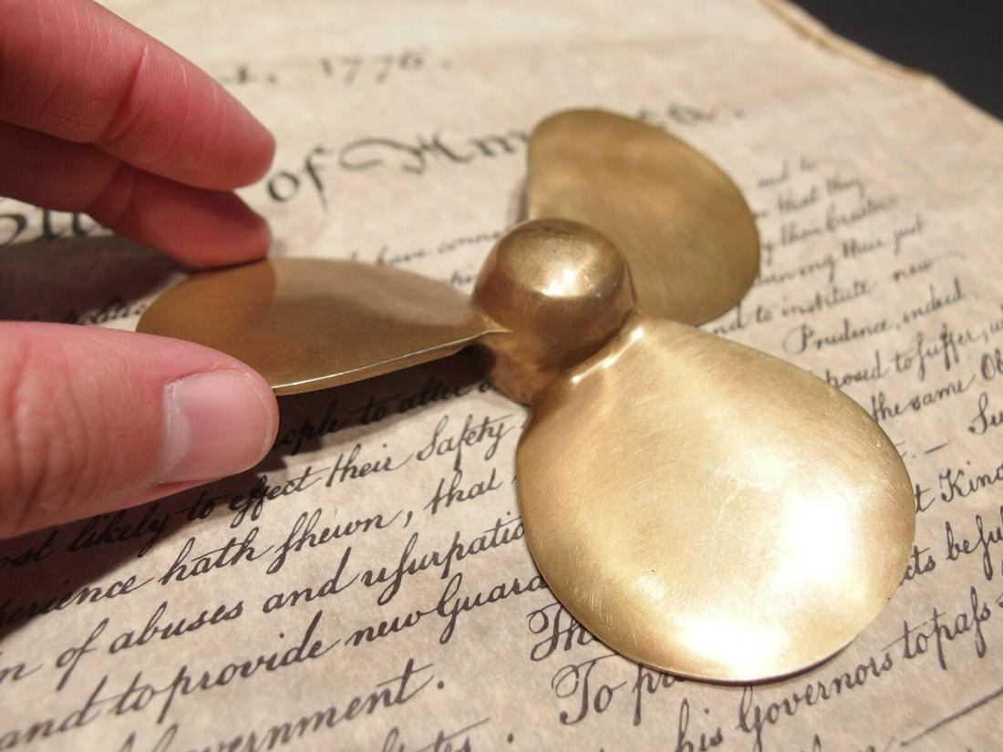 Brass Nautical Boat Propeller Paperweight Desk Figure: 4 1/2" Wide Very accurate and well made reproduction of an antique paperweight. All solid brass, darkened to look old. Certainly easy to wonder its age Reserve: $12.00 Shipping: Domestic: Flat-rate of
