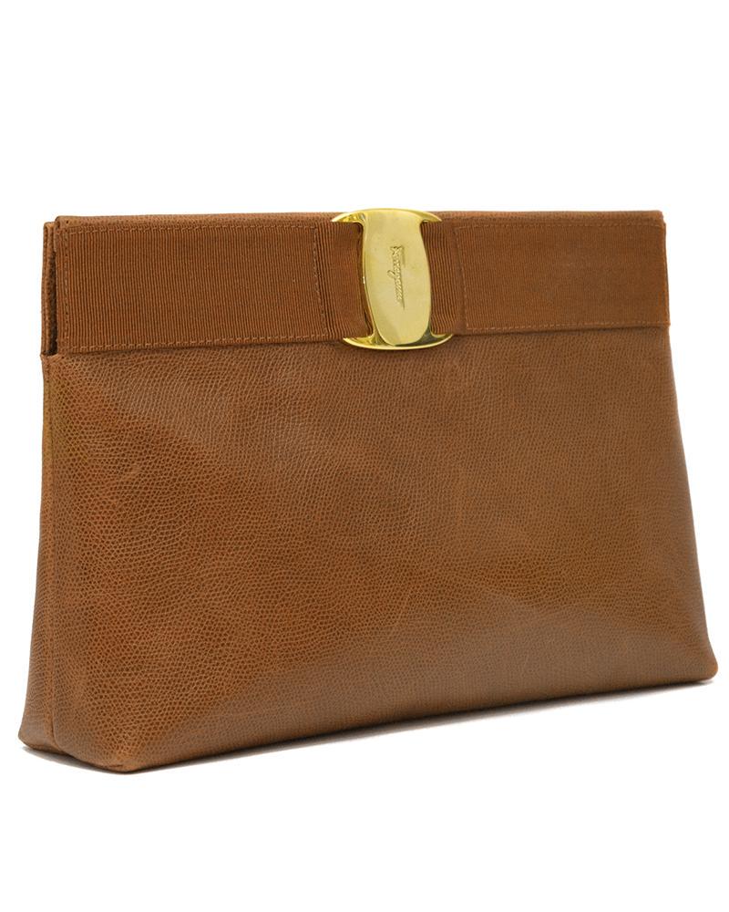 Salvatore Ferragamo Caramel Leather Clutch: Brand: Salvatore Ferragamo Title: Salvatore Ferragamo Caramel Leather Clutch Additional Information: Elegant 1980's Salvatore Ferragamo caramel leather clutch with optional shoulder strap. Features gl