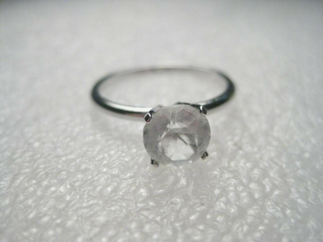 Vintage Silvertone Clear Facet-cut Glass Stone: Vintage but age unknown - 1ctw sized faux diamond (cut glass but not CZ) ring, size 8.25. It is silvertone. It is not sterling silver. It is signed inside the band with an arrow. It is in very good co