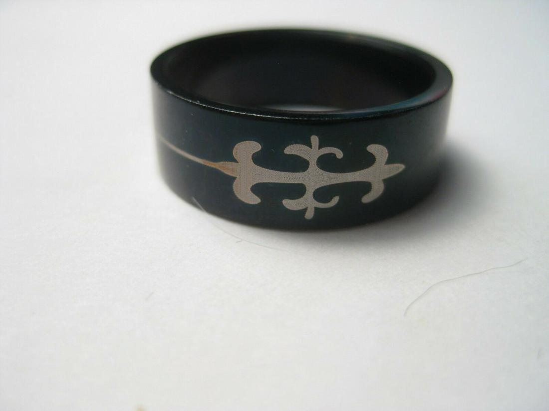 Men's Black Stainless Wedding Ring, Fleur-de-Lis,: Black Stainless Fleur-de-Lis Wedding Band/Ring, Men's Ring, Size 10.25. It is 8mm wide and it has a smooth and shiny surface. It is black with a fleur-de-lis brushed stainless design on each side of t