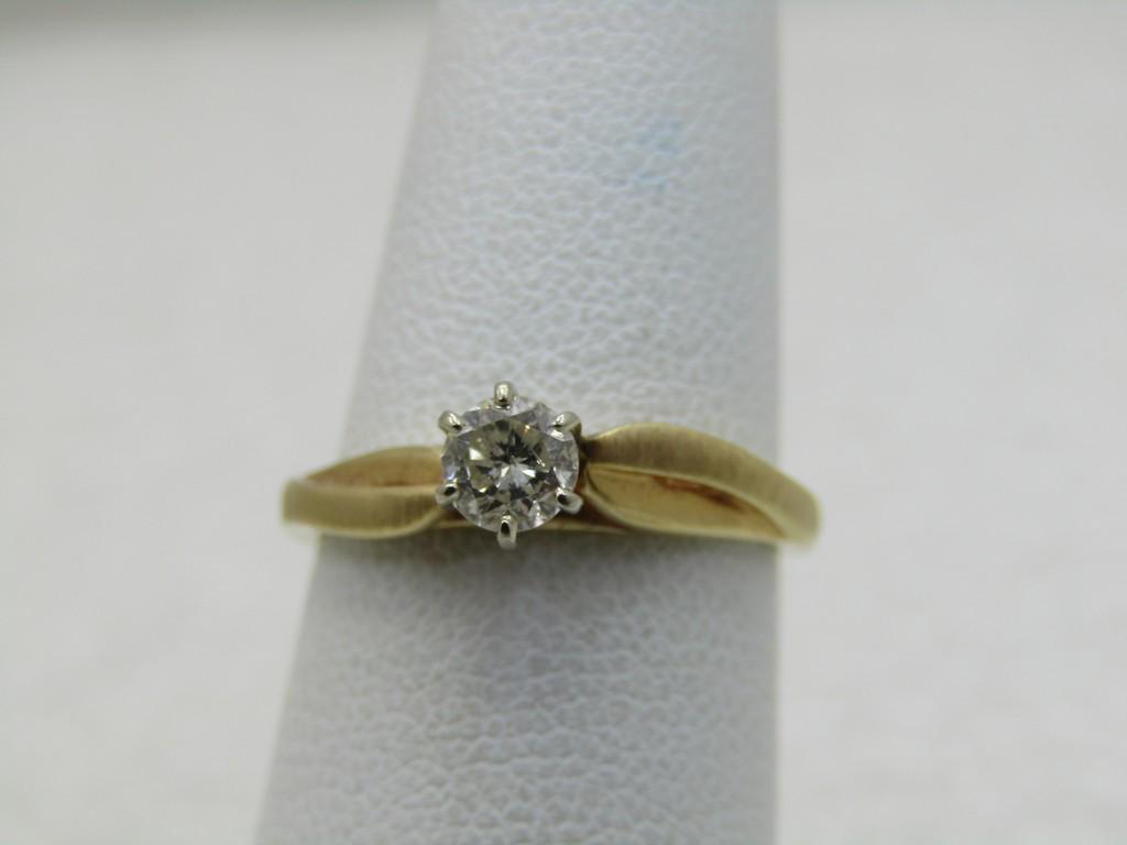 Vintage 14kt Diamond Engagement Ring. .35 TCW, Size 5.5: Vintage 14kt Diamond Engagement Ring. .35 TCW, Size 5.5. Weight is appx. 2.16 grams. The diamond is appx. 4mm across with six prongs holding it. It has a raised band at the sides holding the diamond o