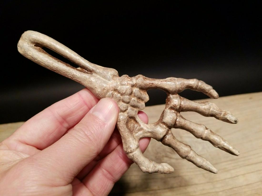 Cast Iron Bone Hand Beer Bottle Opener: 6 5/8" Long x 2 7/8" Wide Great reproduction cast iron bottle opener. This piece was made to look just like an antique, but is new. As you see in the images it is in the form of a skeleton hand. Great