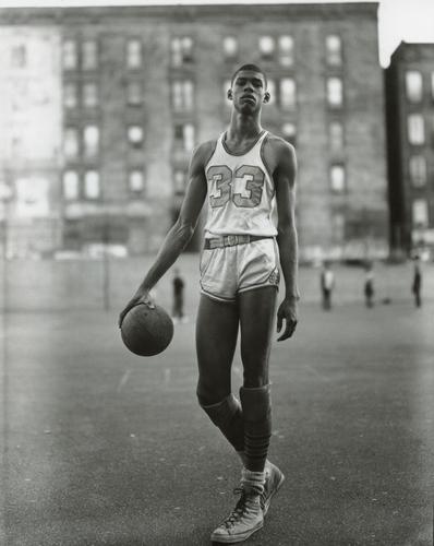 RICHARD AVEDON - Lew Alcindor, 61st St. NYC, 1963: Artist: RICHARD AVEDON Title: Lew Alcindor, 61st Street and Amsterdam Avenue, New York City, 1963 Medium: Photo Litho, 2002, Hong Kong Dimensions: 7.2x9.05" Description: Heat Wax Mounted on 8.5x11" Co