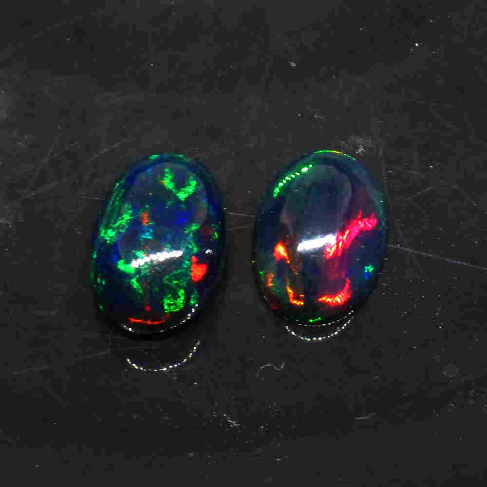 6.31 Ctw Natural Ethiopian Black Fire Opal Oval Pair: Title: 6.31 Ctw Natural Ethiopian Black Fire Opal Oval Pair Stone Clarity: Translucent Gemstone: Black Opal Carat Weight: 6.31 Size/Dimensions: 13.60 x 9.20 x 6.00 mm / 2 PC's Additional Information: 